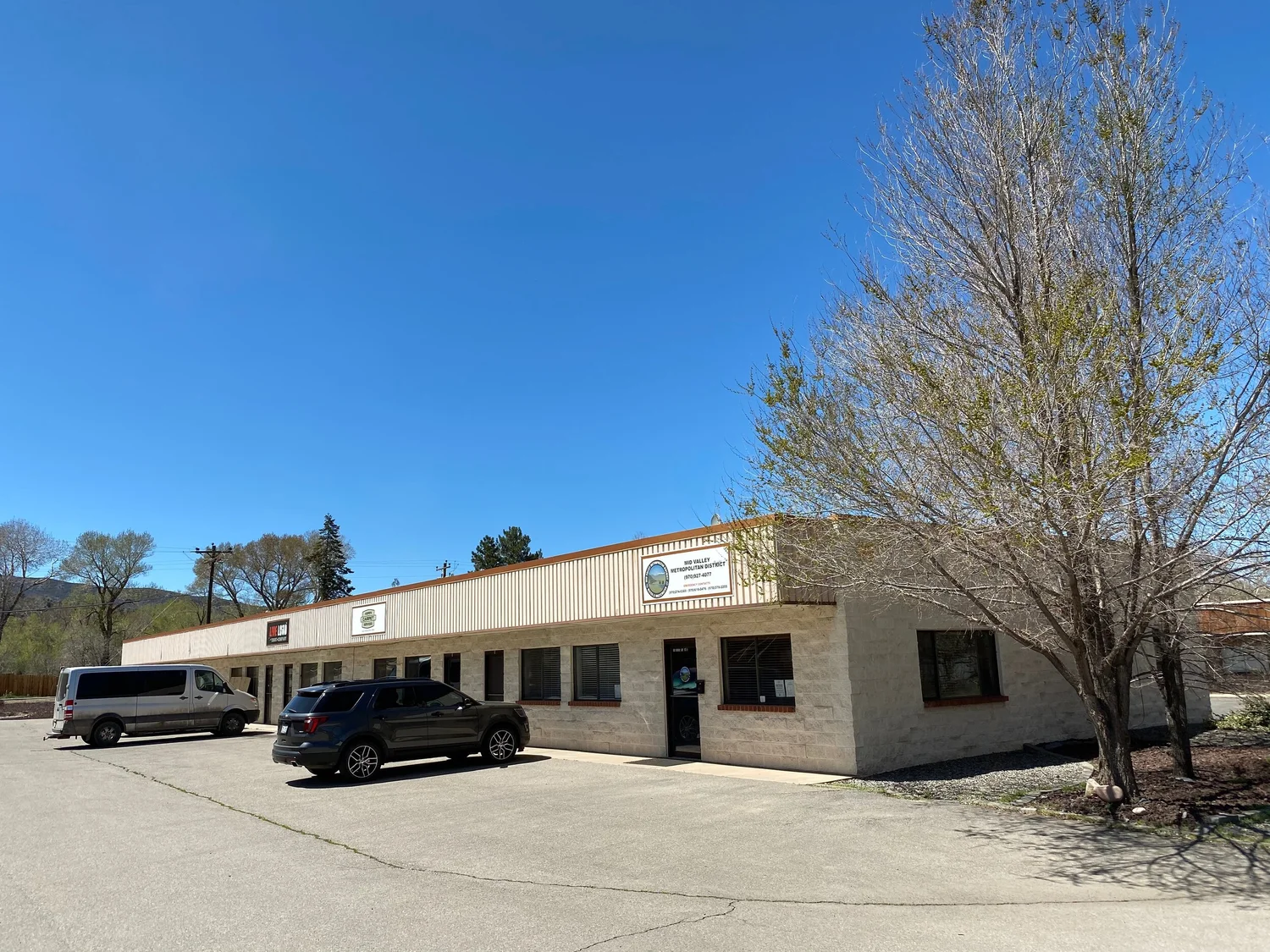 Ground floor commercial units with glass entrance doors and windows opening onto the parking lot at the Basalt property
