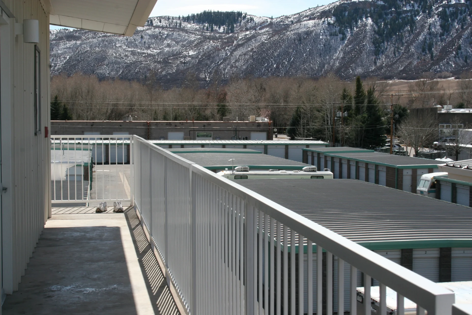 Drive-up storage units at All Hours Storage in Basalt with a snow dusted mountain rising behind the property