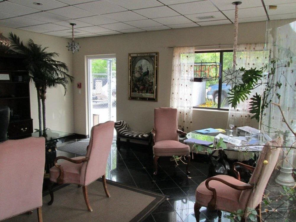 Reception area of the All Hours Storage office in Basalt with a glass front door, an OPEN sign and a meeting table